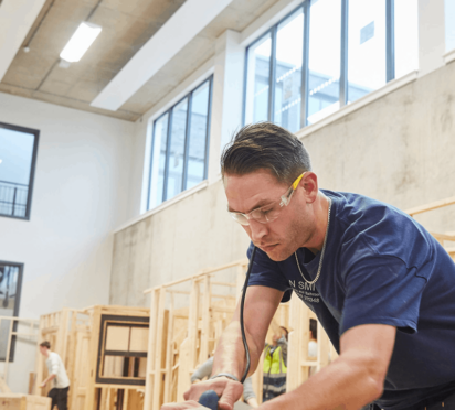 Northbrook college student doing construction work in a workshop