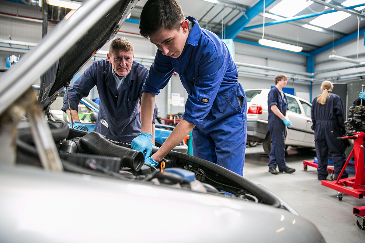 Northbrook college motor vehicle students working on a car engine in the Northbrook college campus garage workshop