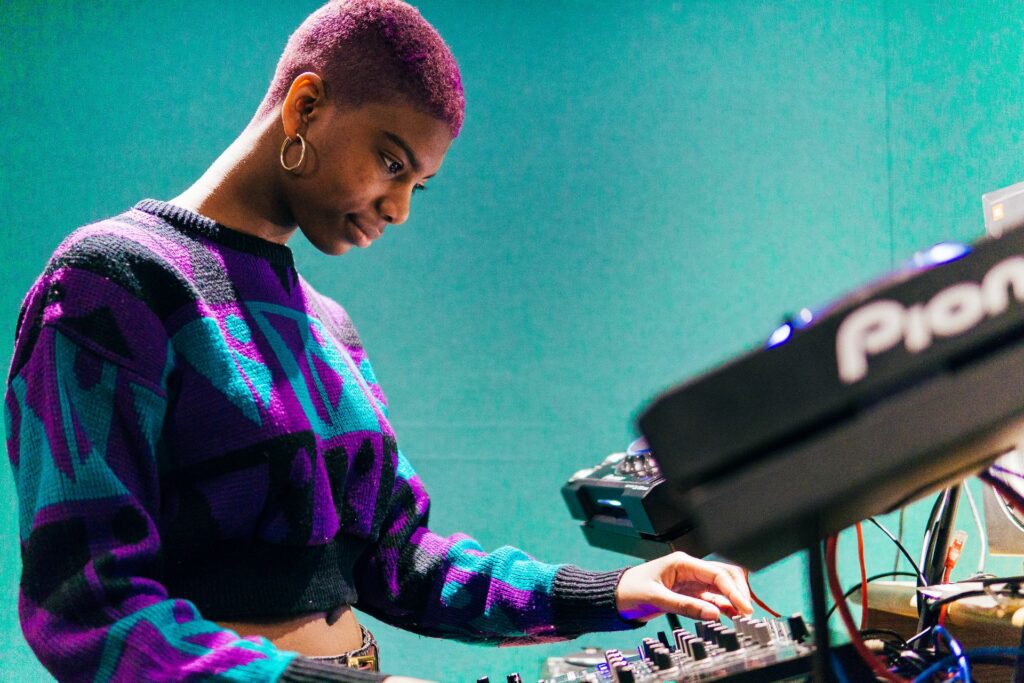 Northbrook college music production student using a synth