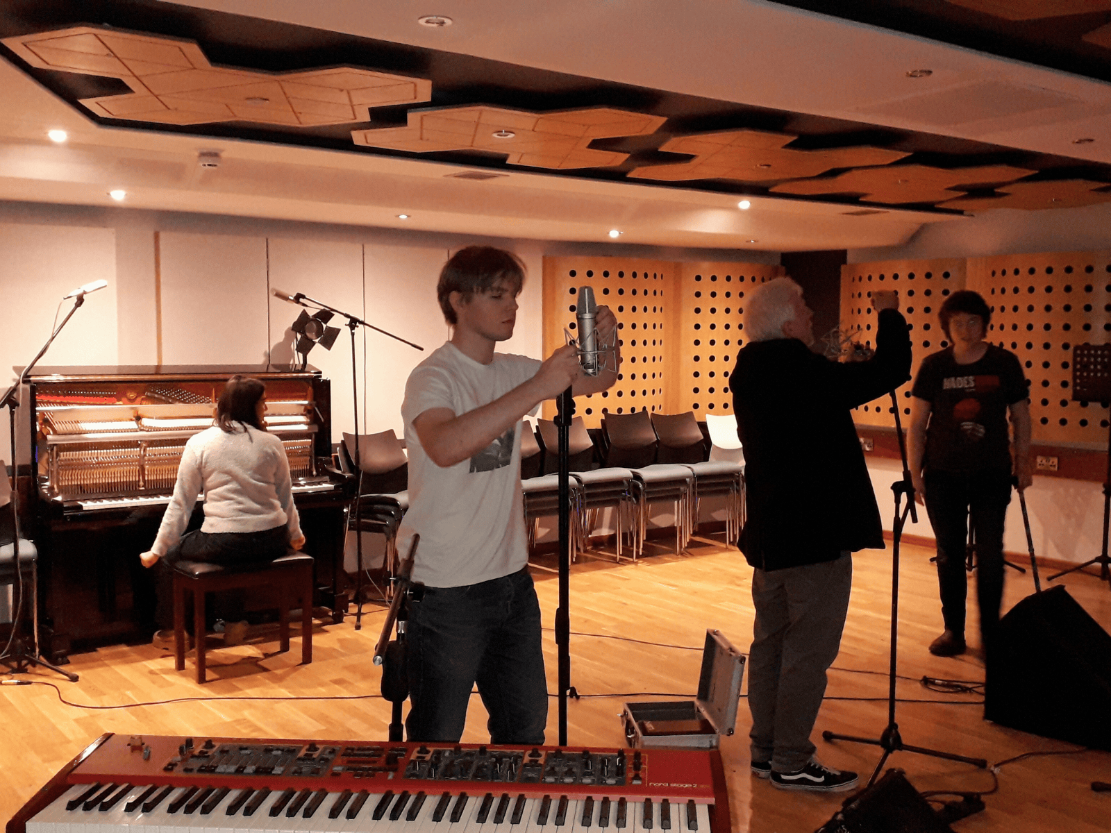 Some of our students setting up mics ahead of the session, with Mahya sat waiting at the piano