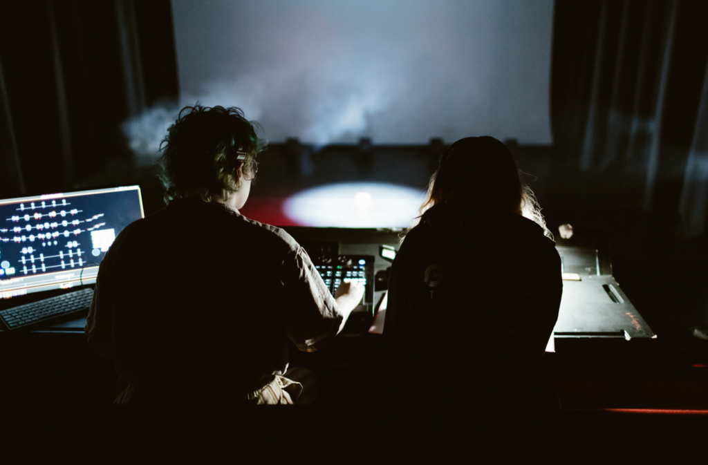 Students using audio and visual equipment desk for the theatre