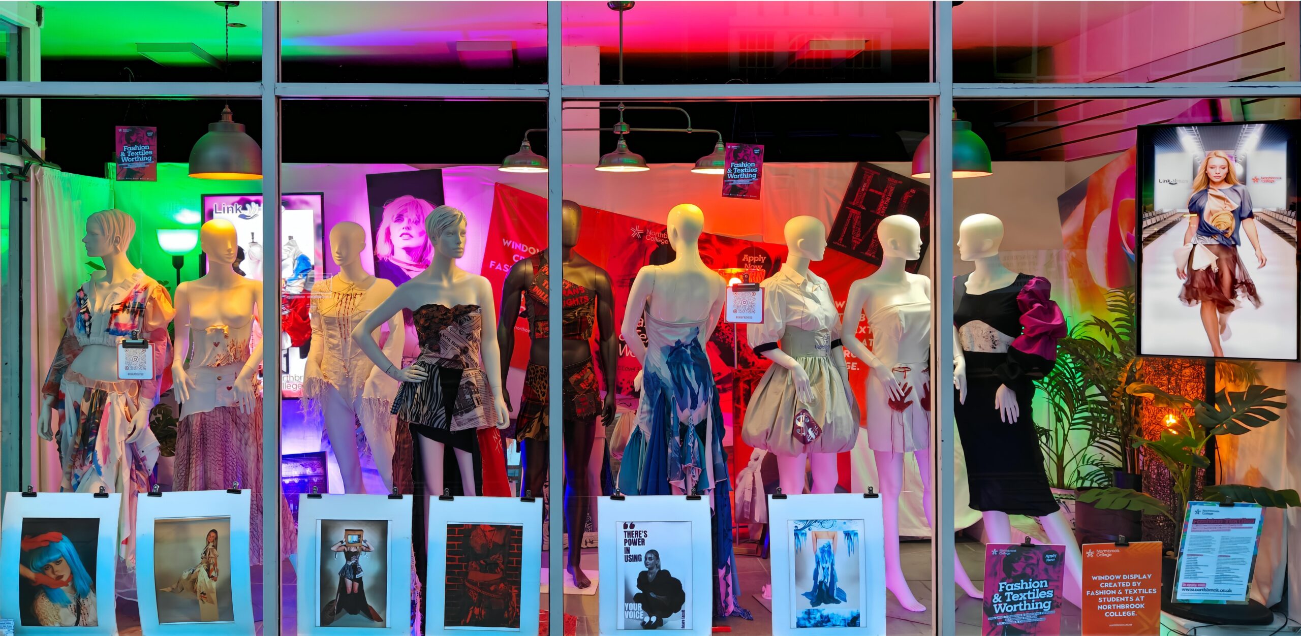 A window display including a variety of our student work on display at the charity shop