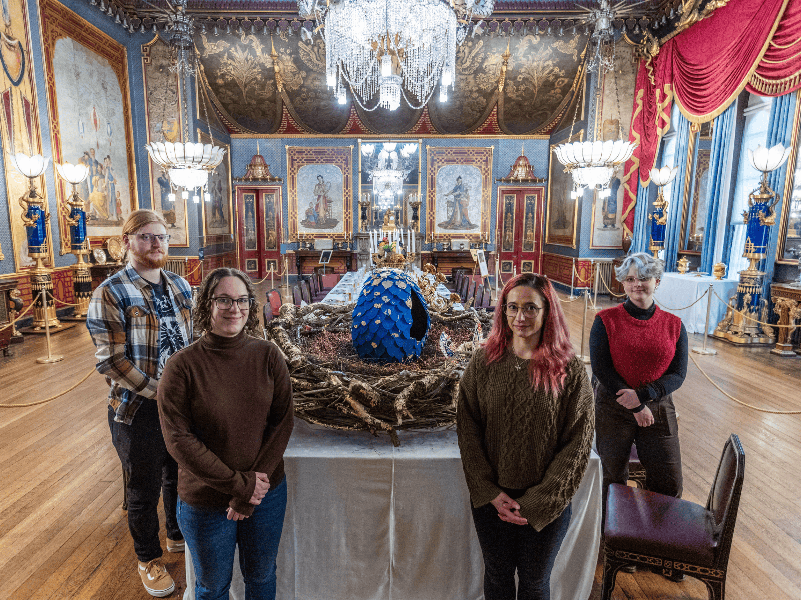 Four of our students stood by their dragon egg, within the Pavilion