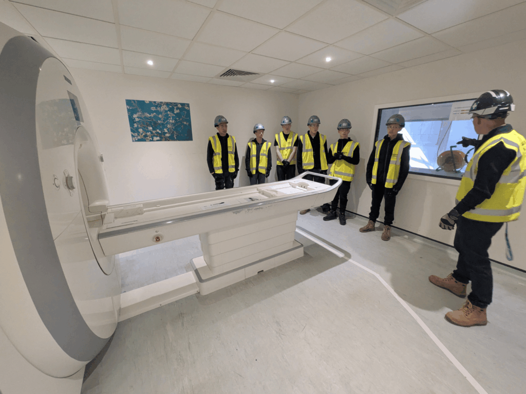 Our construction students stood inspecting the MRI scanner